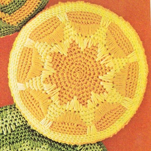 May include: A crocheted yellow and white round cushion with a sunburst design.