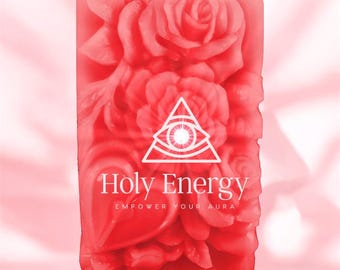 May include: A red soap bar with a floral design and a white triangle with an eye inside. The text "Holy Energy Empower Your Aura" is printed on the bar.