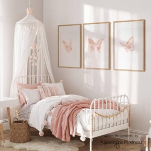 printable butterfly prints set of 3 whole blush pink butterflies. The picture shows how the triptych looks once framed in a girl room over the bed. displayed size 12x18  inch