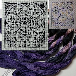 May include: A cross-stitch design with a circular pattern featuring stylized birds and floral elements in black thread on white fabric. The text "MAR-CROW MOON" is at the bottom. Several skeins of purple, black, and grey embroidery floss are in the foreground.