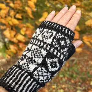 May include: Black and white knit fingerless gloves with a geometric pattern. The gloves are made of a soft, warm yarn and are perfect for keeping your hands warm in the winter.
