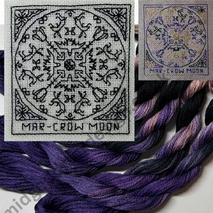 May include: Cross-stitch sampler with a black geometric design featuring birds, flowers, and other shapes, with the text "MAR-CROW MOON" at the bottom. The image includes a skein of purple embroidery floss.