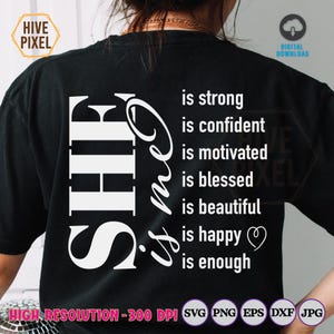 May include: Black t-shirt with white text that reads "SHE is strong, is confident, is motivated, is blessed, is beautiful, is happy, is enough".