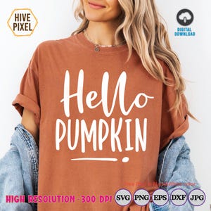 May include: A terracotta-coloured t-shirt with the text "Hello Pumpkin" in white script. The image shows a digital download, indicated by the icon. The image also includes the "Hive Pixel" logo and file type icons.