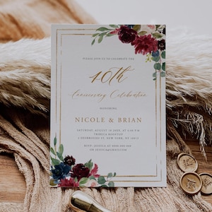 May include: A formal invitation for a 40th anniversary celebration. The invitation features gold lettering and a gold border, with floral accents in burgundy, navy, and green. The text includes the names Nicole & Brian, date, time, and location.