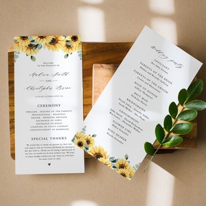 May include: Wedding ceremony programs with sunflower and eucalyptus accents. The programs feature the names of the couple, ceremony details, and wedding party information. The design includes the text "Welcome to the Wedding of" and "The Blossom Designs".