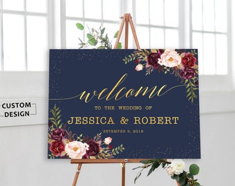 May include: A navy blue wedding welcome sign with gold lettering and a floral design. The sign reads "Welcome to the Wedding of Jessica & Robert September 9, 2019".