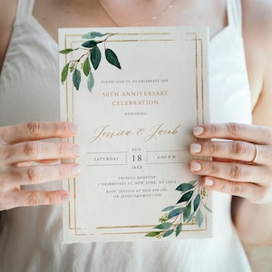 May include: A cream-colored invitation for a 50th-anniversary celebration. The invitation features gold borders and botanical watercolor accents. The text reads "Jessica & Jacob" and includes the date, time, and location. The Blossom Designs logo is at the bottom.
