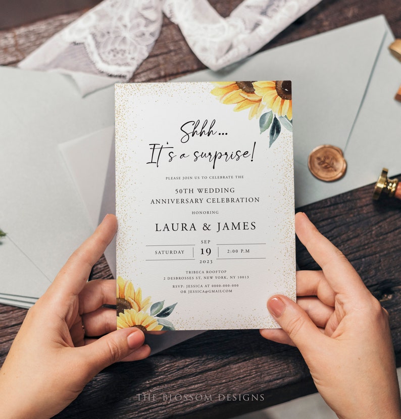 May include: A white invitation card with gold glitter and a watercolor sunflower design. The text reads "Shhh... It's a surprise!" and announces a 50th wedding anniversary celebration for Laura & James on September 19, 2023, at 2:00 PM at the Tribeca Rooftop in New York City.
