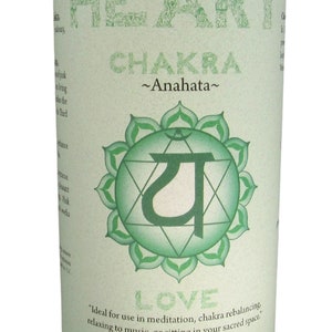 May include: Green candle with a label that says "Heart Chakra ~Anahata~" and a green symbol with the word "LOVE" below it. The label also says "Ideal for use in meditation, chakra rebalancing, relaxing to music, or sitting in your sacred space. Essential Oil Fragrance Blend: rose, geranium Crystal Journey Candles"