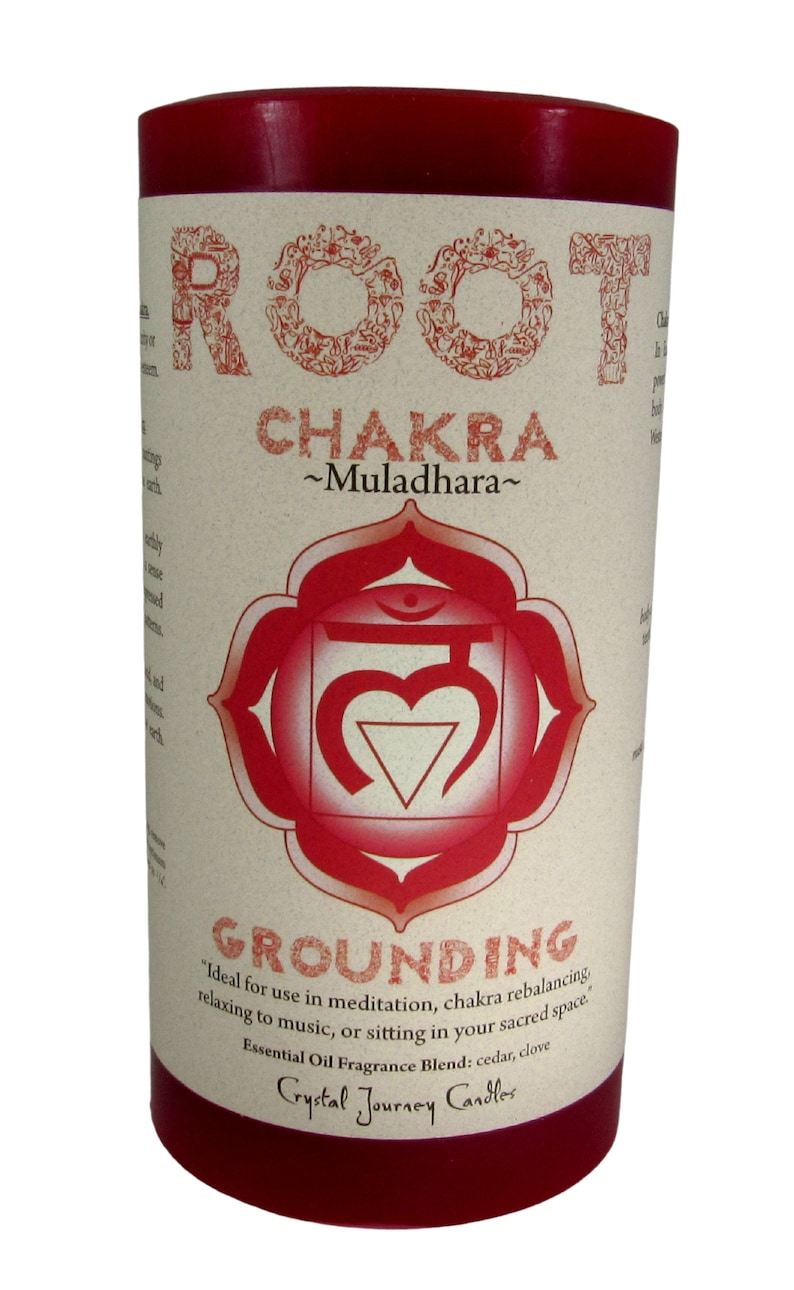 May include: Red candle with a white label that says "ROOT CHAKRA ~Muladhara~" and "GROUNDING" with a red symbol in the center. The label also says "Ideal for use in meditation, chakra rebalancing, relaxing to music, or sitting in your sacred space. Essential Oil Fragrance Blend: cedar, clove Crystal Journey Candles"