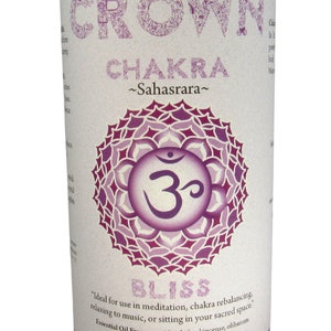 May include: Purple candle with a white label that says "Crown Chakra ~Sahasrara~" and features a purple and white mandala with the symbol "Om" in the center. The label also says "Bliss" and "Ideal for use in meditation, chakra rebalancing, relaxing to music, or sitting in your sacred space. Essential Oil Fragrance Blend: frankincense, olibanum Crystal Journey Candles"