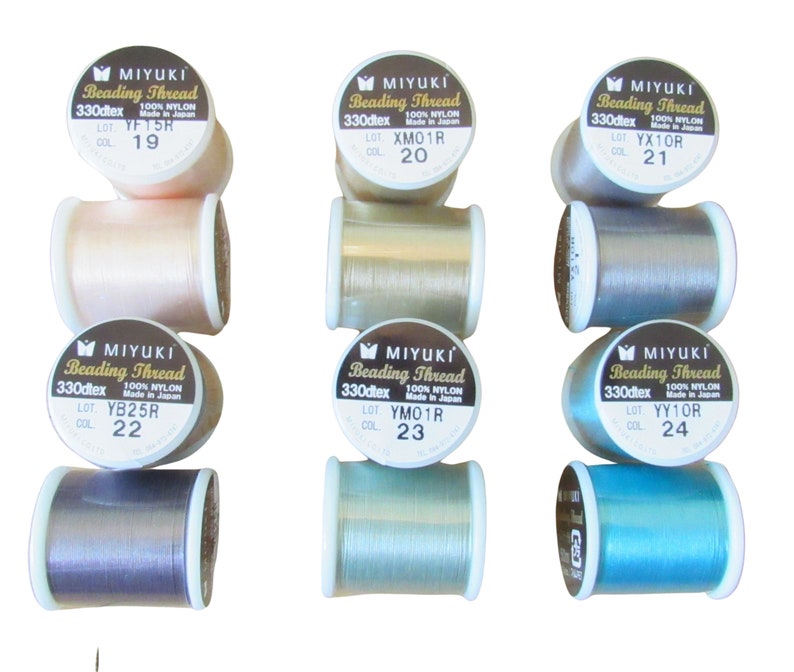 May include: Six spools of Miyuki Beading Thread made of 100% nylon, 330dtex. The spools are arranged in two columns of three, featuring various colors including light pink, pale yellow, grey, purple, light green, and bright blue.