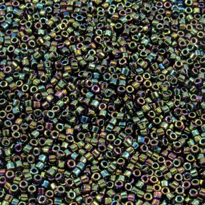 May include: A close-up image of a large quantity of iridescent seed beads. The beads are a mix of dark green, blue, and purple colors.