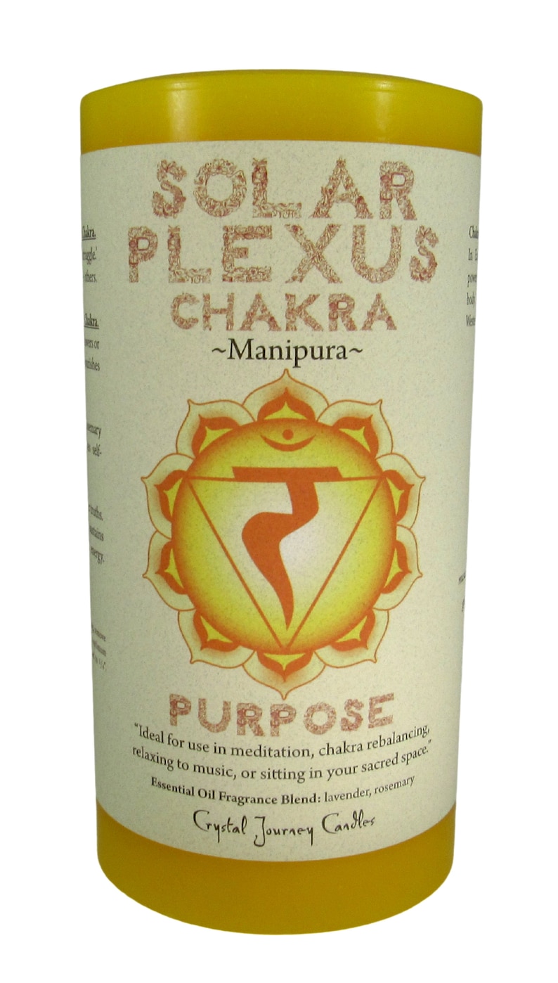 May include: Yellow candle with a white label that says "Solar Plexus Chakra ~Manipura~" and features a yellow and orange chakra symbol. The label also says "Purpose" and "Ideal for use in meditation, chakra rebalancing, relaxing to music, or sitting in your sacred space. Essential Oil Fragrance Blend: lavender, rosemary Crystal Journey Candles."