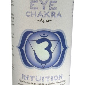 May include: A blue candle with a white label that says "Third Eye Chakra ~Ajna~" and features a blue and white symbol. The label also says "Intuition" and "Ideal for use in meditation, chakra rebalancing, relaxing to music, or sitting in your sacred space." The label also says "Essential Oil Fragrance Blend: jasmine, vetiver" and "Crystal Journey Candles."