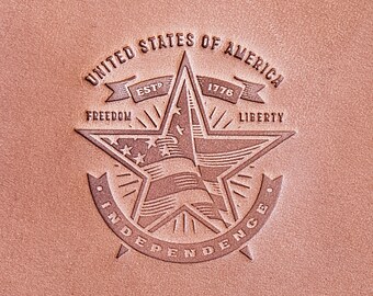 May include: A brown leather patch with an embossed design of a five-pointed star with the words "United States of America", "Est. 1776", "Freedom", "Liberty", and "Independence" around it.
