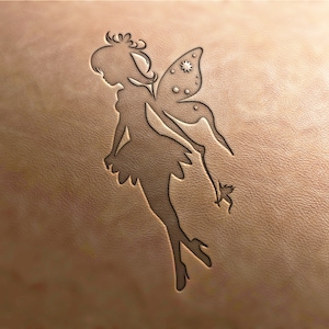 May include: A brown leather background with a black silhouette of a fairy with wings and a star pattern. The fairy is flying with one foot raised.