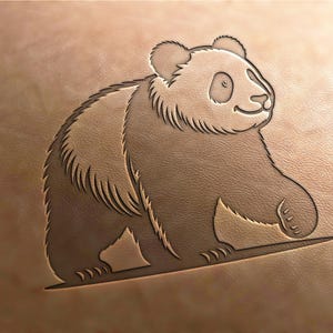 May include: A black and white line drawing of a panda bear on a brown leather background. The panda is facing to the right and has a friendly expression.