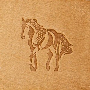 May include: A brown leather patch featuring a stylised image of a horse in a running pose. The horse is outlined in a darker brown colour.