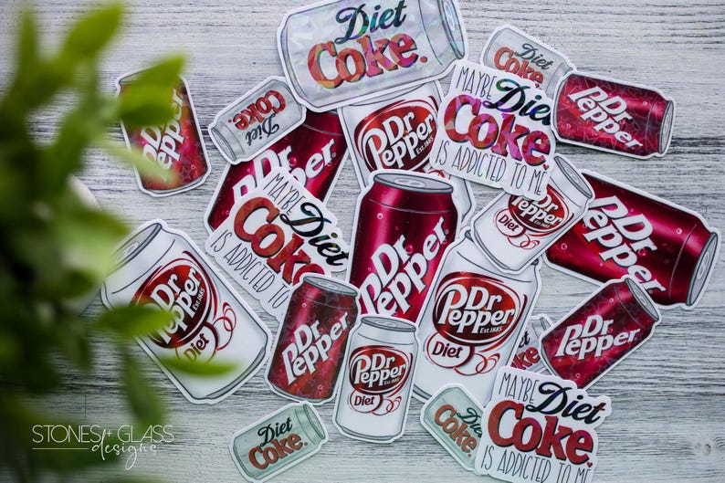 May include: A collection of stickers featuring Diet Coke and Dr. Pepper soda cans. The stickers are in various sizes and orientations, with the words "Diet Coke" and "Dr. Pepper" prominently displayed. The phrase "Maybe Diet Coke is addicted to me" is also visible.