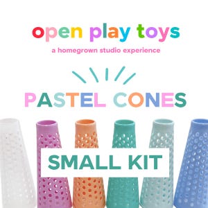 May include: A set of six conical toys with a perforated texture in white, pink, orange, teal, light blue, and periwinkle. The text reads open play toys, a homegrown studio experience, PASTEL CONES, and SMALL KIT in colorful lettering.