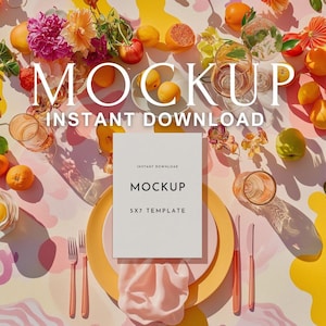 May include: A styled mockup scene featuring a white 5x7 template card with the word "MOCKUP" in black text. The scene includes a yellow plate, pink napkin, and rose gold cutlery. Fresh fruit and flowers are scattered around the card.