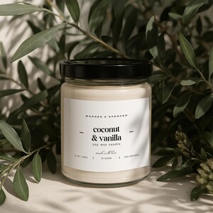 May include: A clear glass jar candle with a black lid. The label reads "WARNER & SPENCER", "coconut & vanilla", "soy wax candle", "made with love", "30 HOURS", and "100% NATURAL".
