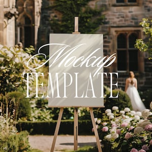 May include: A white easel with a blank canvas in front of a stone building and green foliage. The canvas is a mockup template.