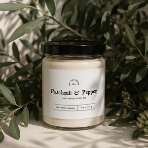 May include: A glass jar candle with a black lid and a white label. The label reads "Soy Wax Candle No.1 Patchouli & Pepper and Sandalwood Oil 100% natural components 7 oz / 120 g".