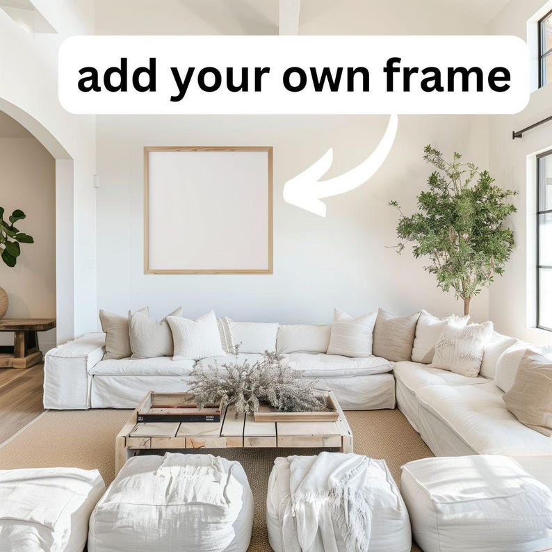 May include: A white sectional sofa with a wooden coffee table and a white frame on the wall. The text "add your own frame" is written on the wall above the frame.
