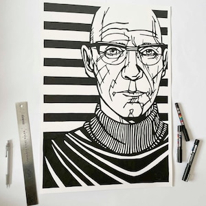 May include: Black and white illustration of a man wearing glasses and a turtleneck sweater. The artwork features bold lines and a striped background. A metal ruler and pens are next to the artwork.