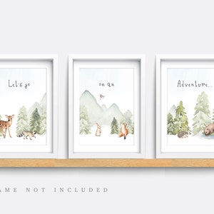May include: Three framed watercolor prints with forest scenes. Each print features a different phrase: "Let's go", "on an", and "Adventure...". The artwork includes deer, raccoon, rabbit, fox, hedgehog, and bear illustrations.