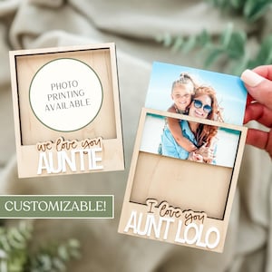 May include: Two wooden photo frames with customizable text. One frame reads "We love you Auntie" and the other reads "I love you Aunt Lolo". The frames have a slot to hold a photo. The text "Photo Printing Available" is also visible.