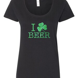 May include: Black t-shirt with a green shamrock and the text "I ♥ BEER" in green glitter.