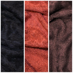May include: Three fabric swatches in different shades of brown. The swatches are soft and fuzzy, with a plush texture.