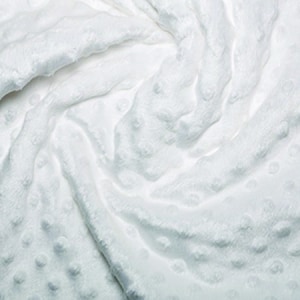 May include: White plush fabric with a textured, dotted pattern. The fabric is soft and fluffy, and it is perfect for making blankets, pillows, or other soft goods.