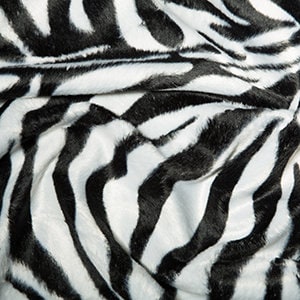 May include: Black and white zebra print fabric with a soft, plush texture.