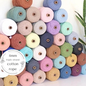 May include: A variety of colours of 4mm triple strand cotton rope. The rope is wound into balls and stacked in a pyramid shape. The text "4mm triple strand cotton rope" is written on a white circle.