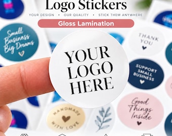 May include: A circular white sticker with the black text YOUR LOGO HERE printed in the center. The sticker is part of a larger sheet containing various other circular stickers with different designs, colors, and text including Thank You.