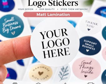 May include: A circular white sticker with the black text YOUR LOGO HERE, presented on a sheet of various round stickers featuring designs like Small Business Big Dreams, Thank You, and Handmade With Love, all with a matte lamination finish.