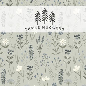 May include: A floral pattern with green, white, and blue flowers and foliage on a light grey backdrop. The design includes the text "THREE HUGGERS" and three stylized tree illustrations.