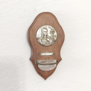 Vintage silver plate virgin Mary on a wooden wall plaque with glass container for holy water circa 1940