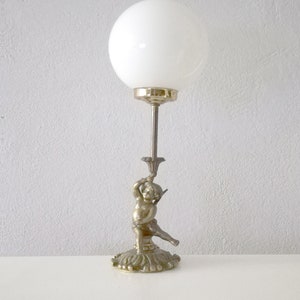 Art Nouveau bronze table lamp with cherub or putti and a white glass globe circa 1930 from Spain