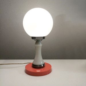 Pop era orange and chrome side table lamp with white opaline globe circa 1960 Space age table lamp with glass shade