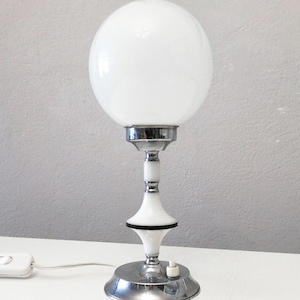 Pop era chrome and white table lamp with white opaline globe from the circa 1960 Small chrome and white side lamp with glass globe