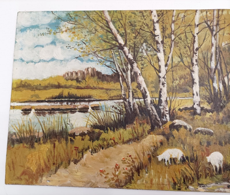May include: A painting of a landscape with a river, trees, and a dirt path. The trees are mostly birch trees with white bark. The river is blue and green and there are some rocks in the water. The path is dirt and leads to the river. There are some small white sheep in the grass near the river.