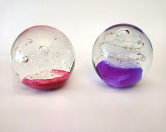 Two vintage paperweights in pink and purple glass paperweight circa 1990