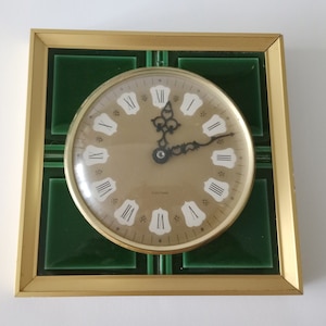 Mid century green ceramic wall clock with gold coloured metal frame made by SARS in Germany from the 1960s MCM kitchen clock