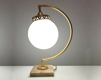Art Deco inspired curved mid century vintage lamp in gold metal with opaline globe from the 70s